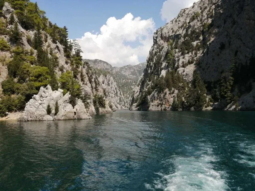 Still green water between steep limestone cliffs in the Green Canyon gorge