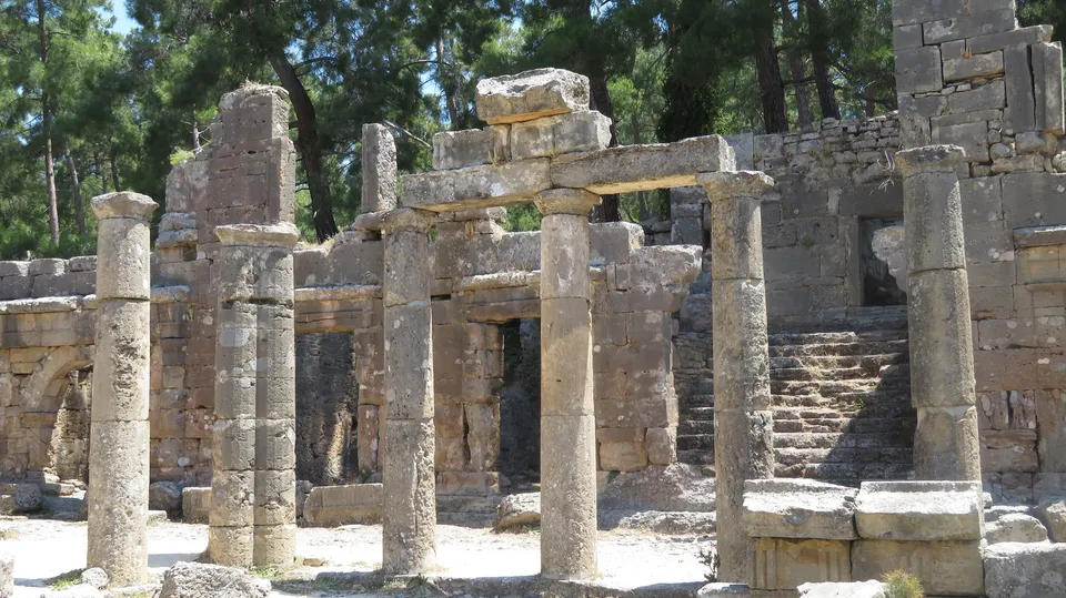Doric columns and entablature of the two-storey agora at Lyrbe, with a stone staircase rising to the upper level